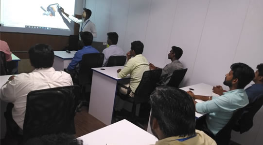 Corporate employees reviewing a CAD design during a training session