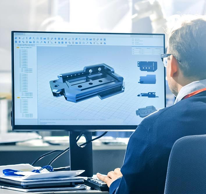 Engineer reviewing a CAD assembly model on a monitor